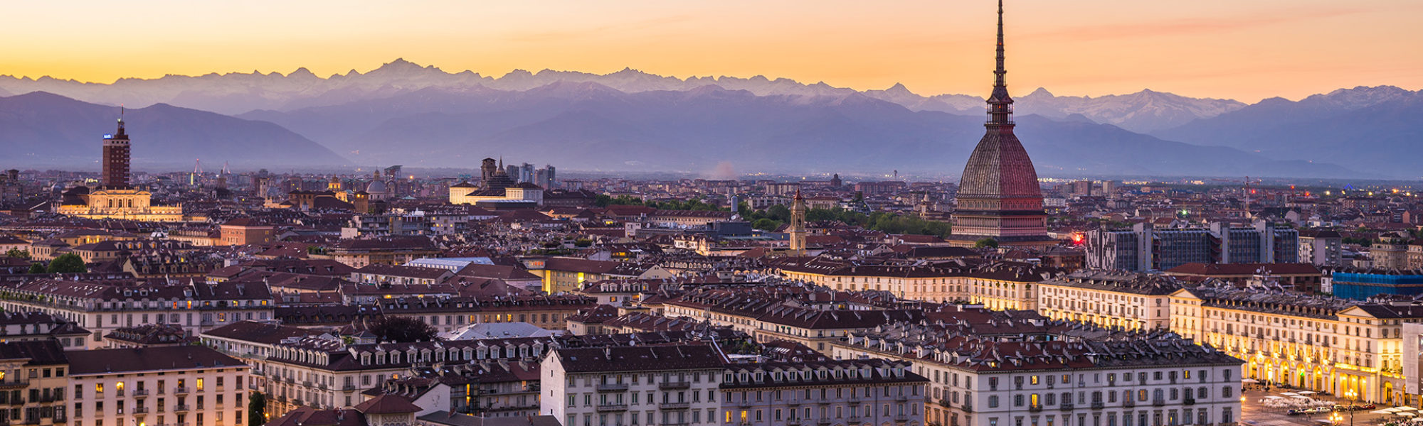 Cityscape of Torino (Turin, Italy) at sunsetwith colorful clear sky. The Mole Antonelliana towering on the city.